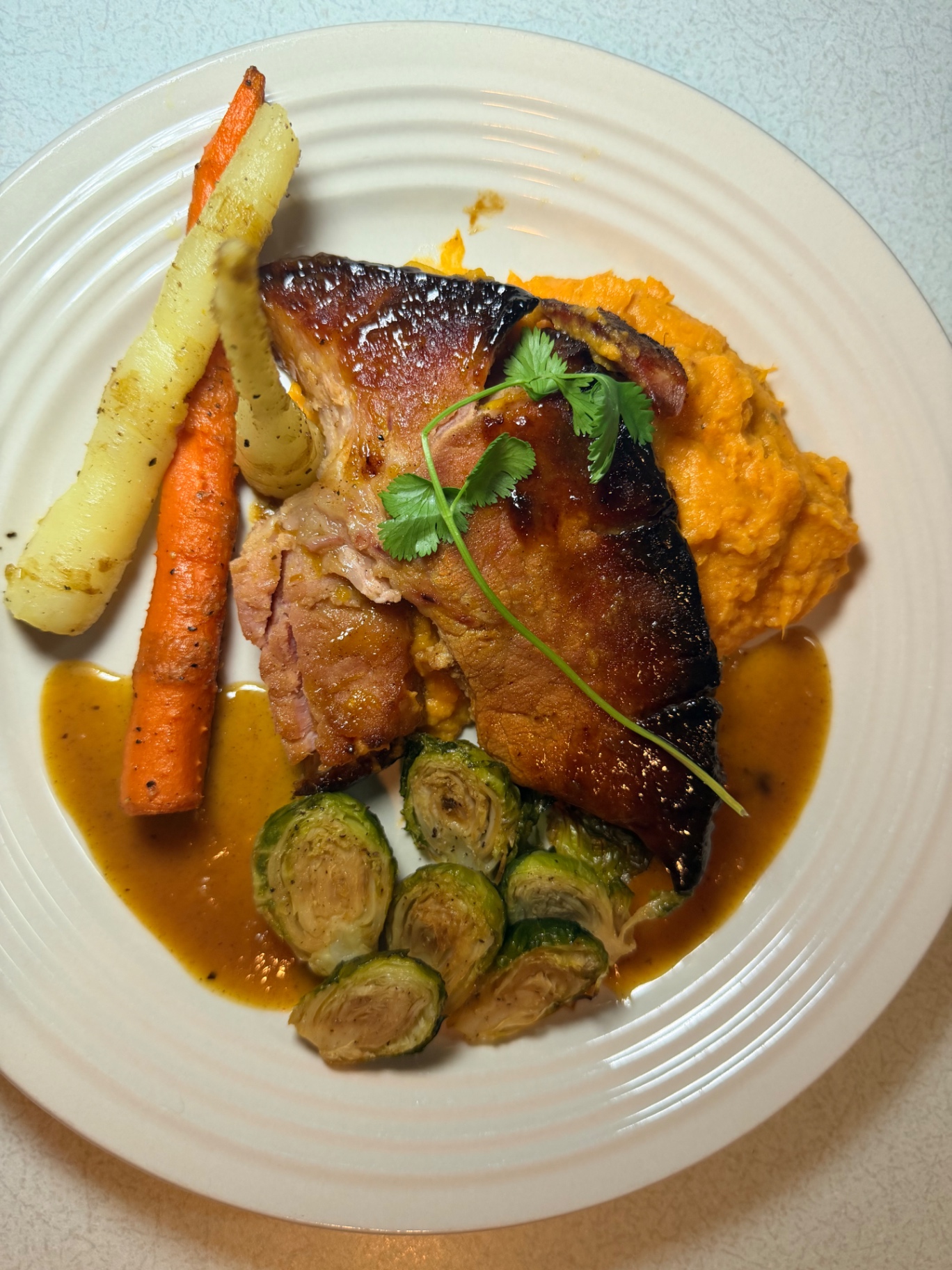 Roasted entrée with glazed vegetables and seasonal garnish